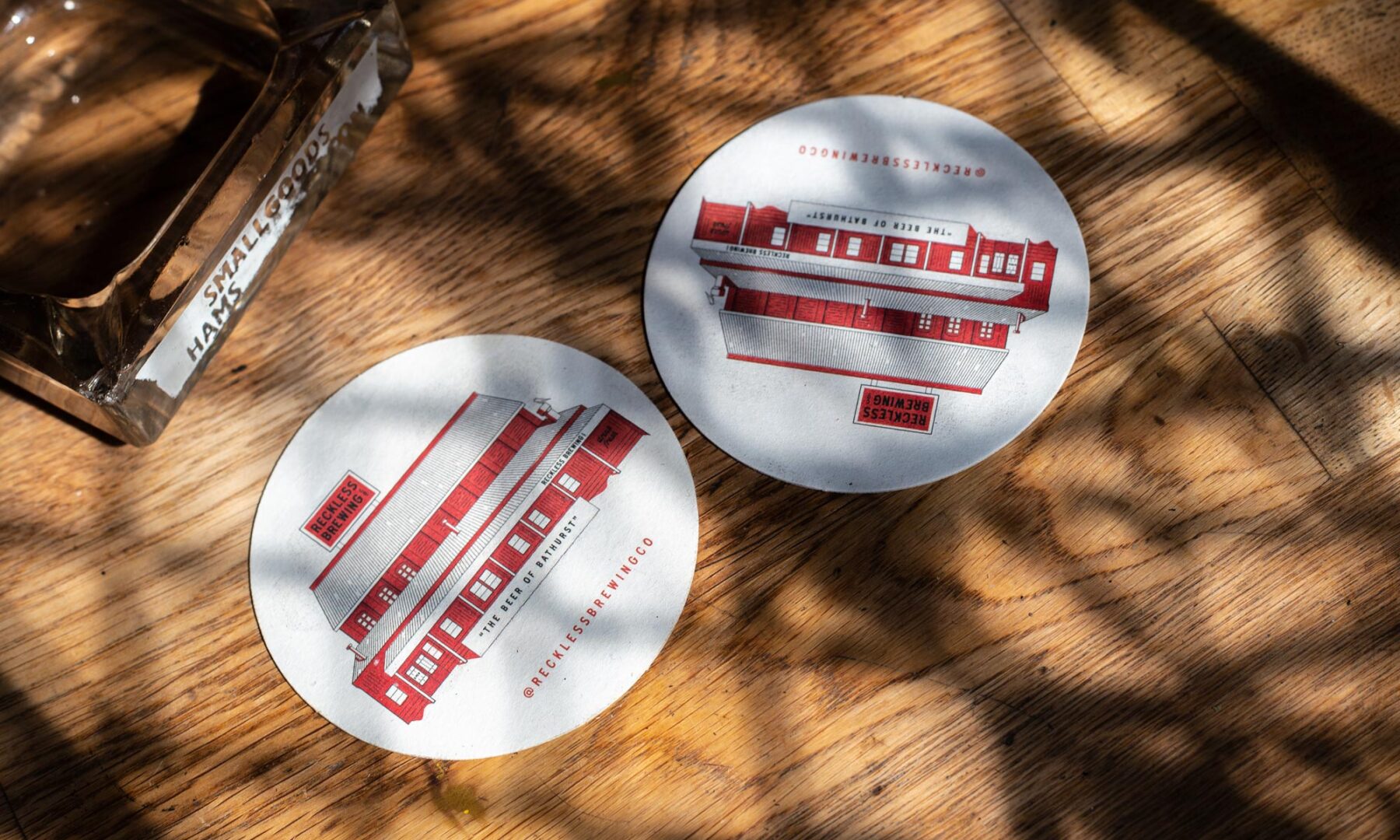 Reckless Brewing coasters on dappled background