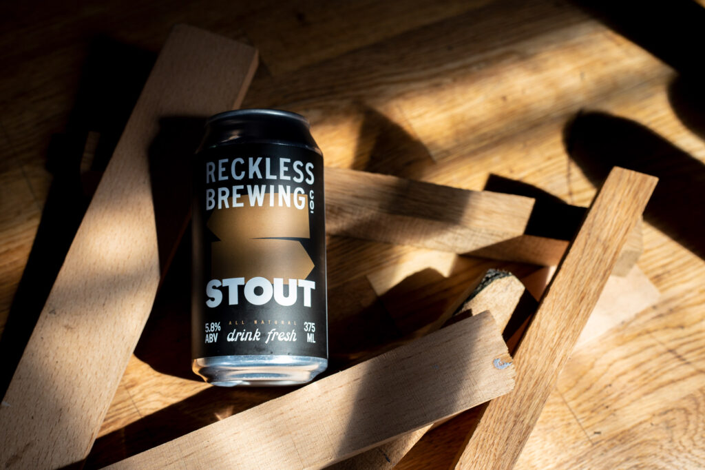 Reckless Brewing Stout beer can on wooden background