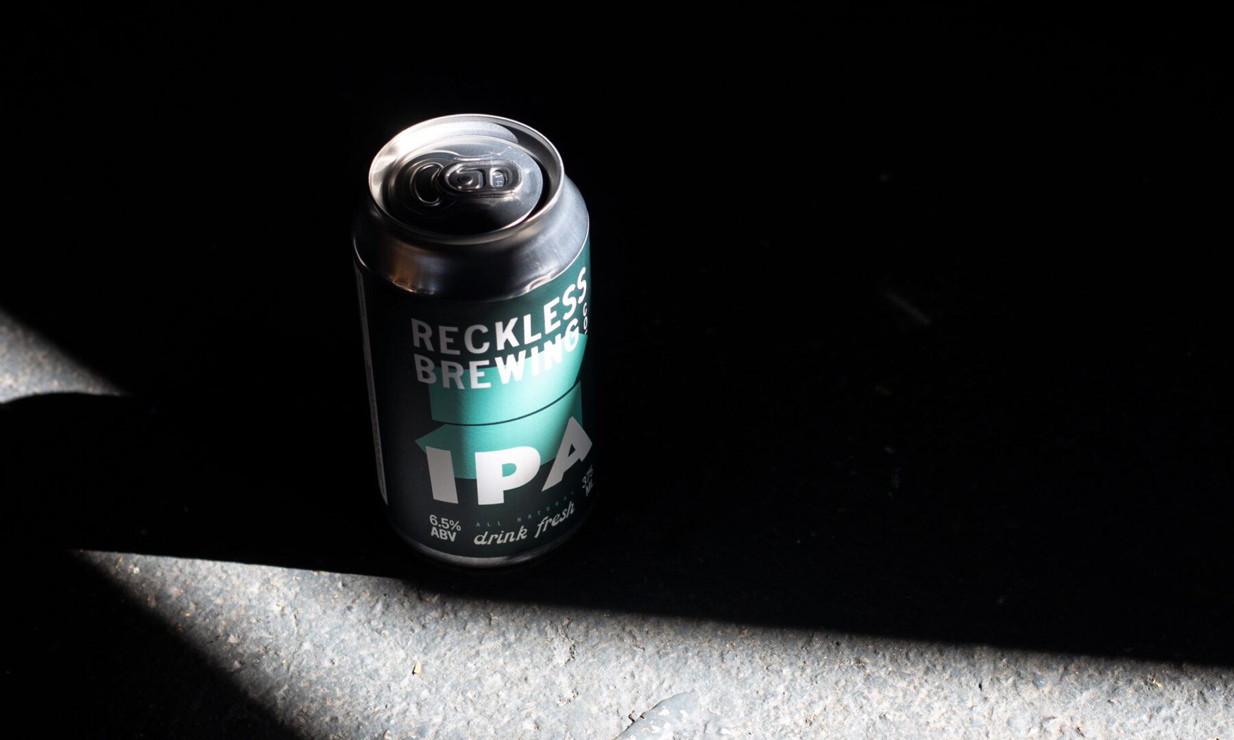 Reckless Brewing IPA can on moody background